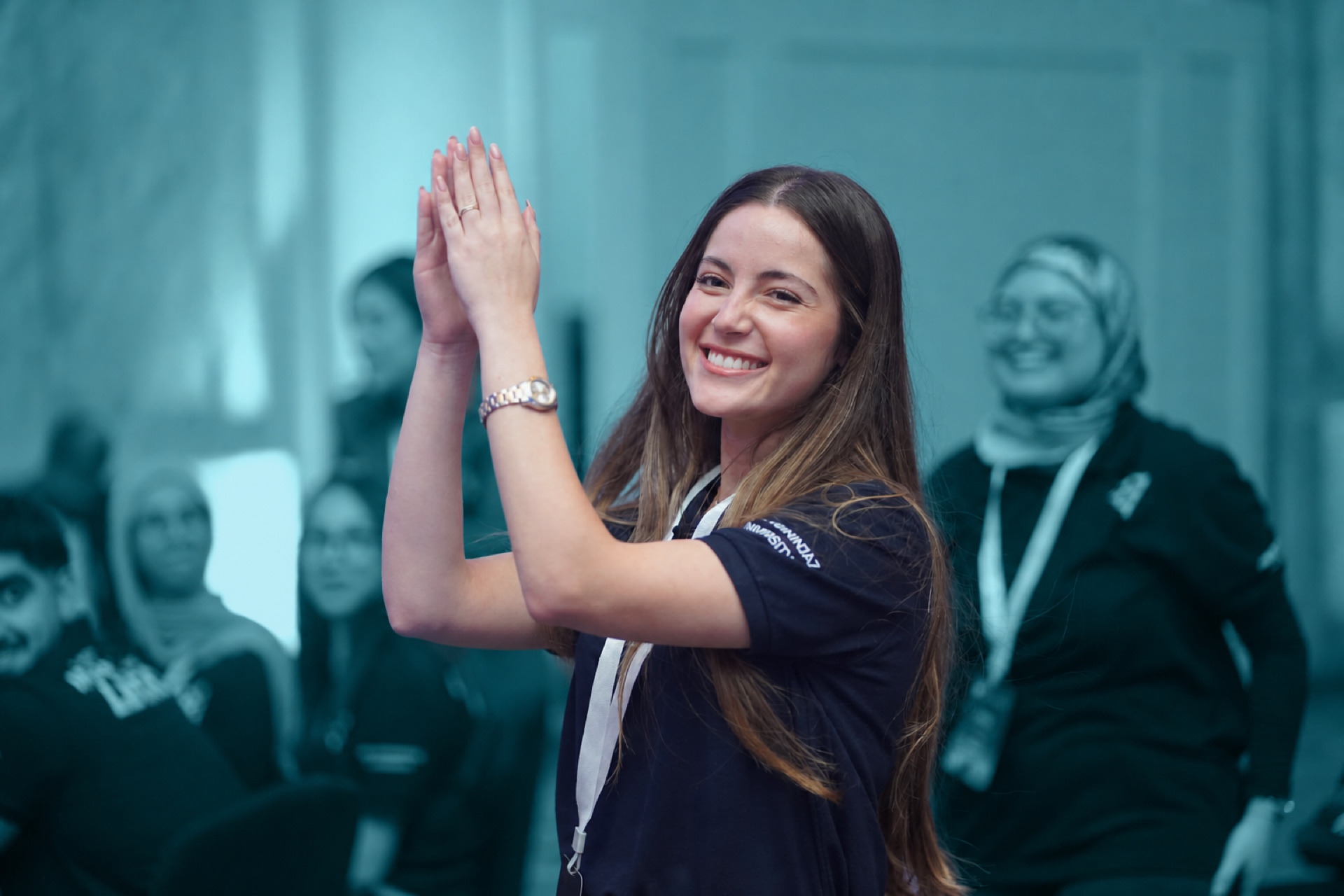 A student applauding at the celebration