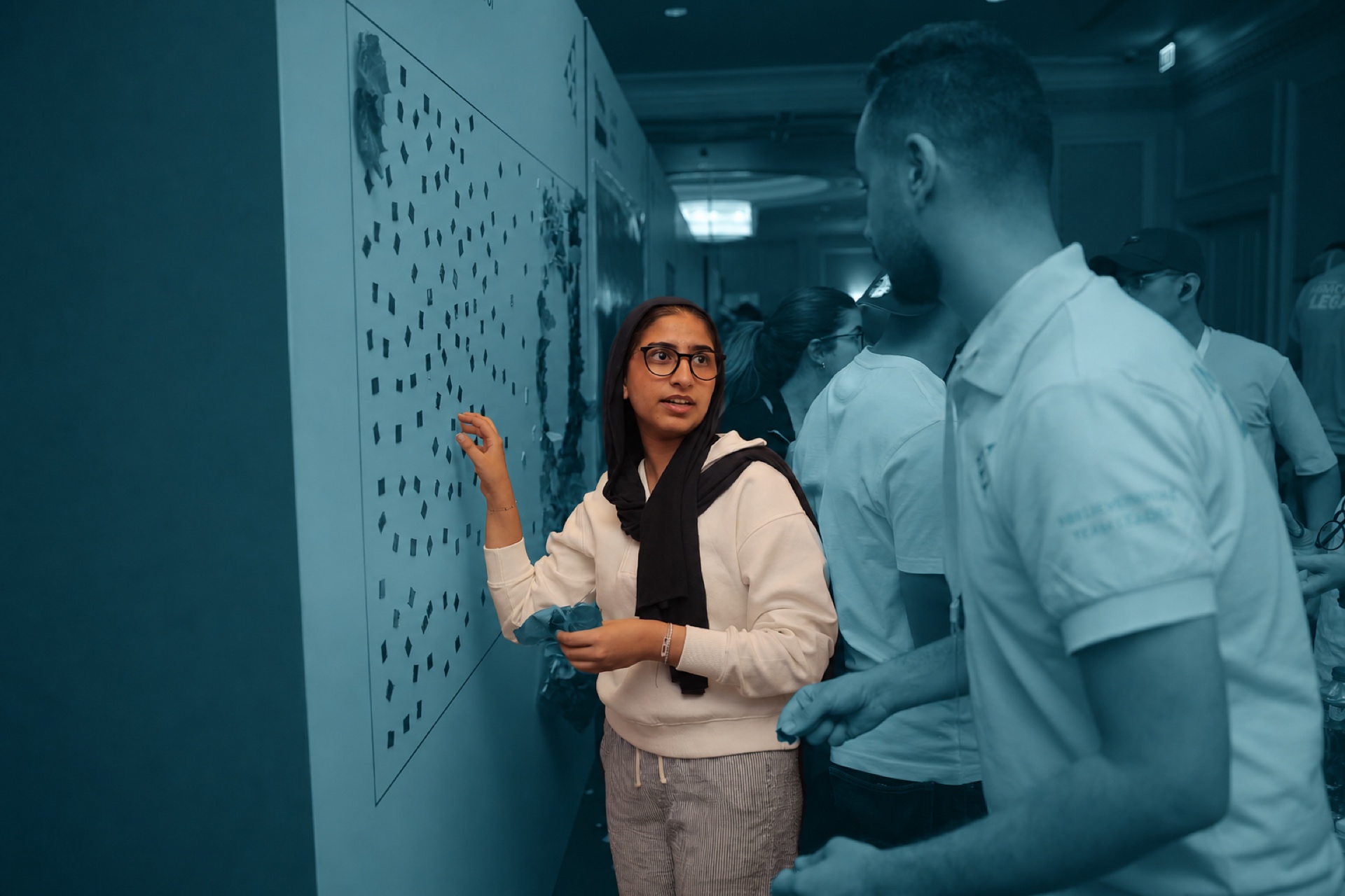 A participant adding to the interactive impact wall