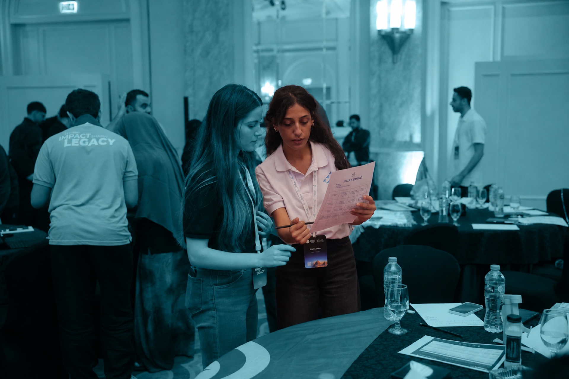Participants networking with an INJAZ activity sheet