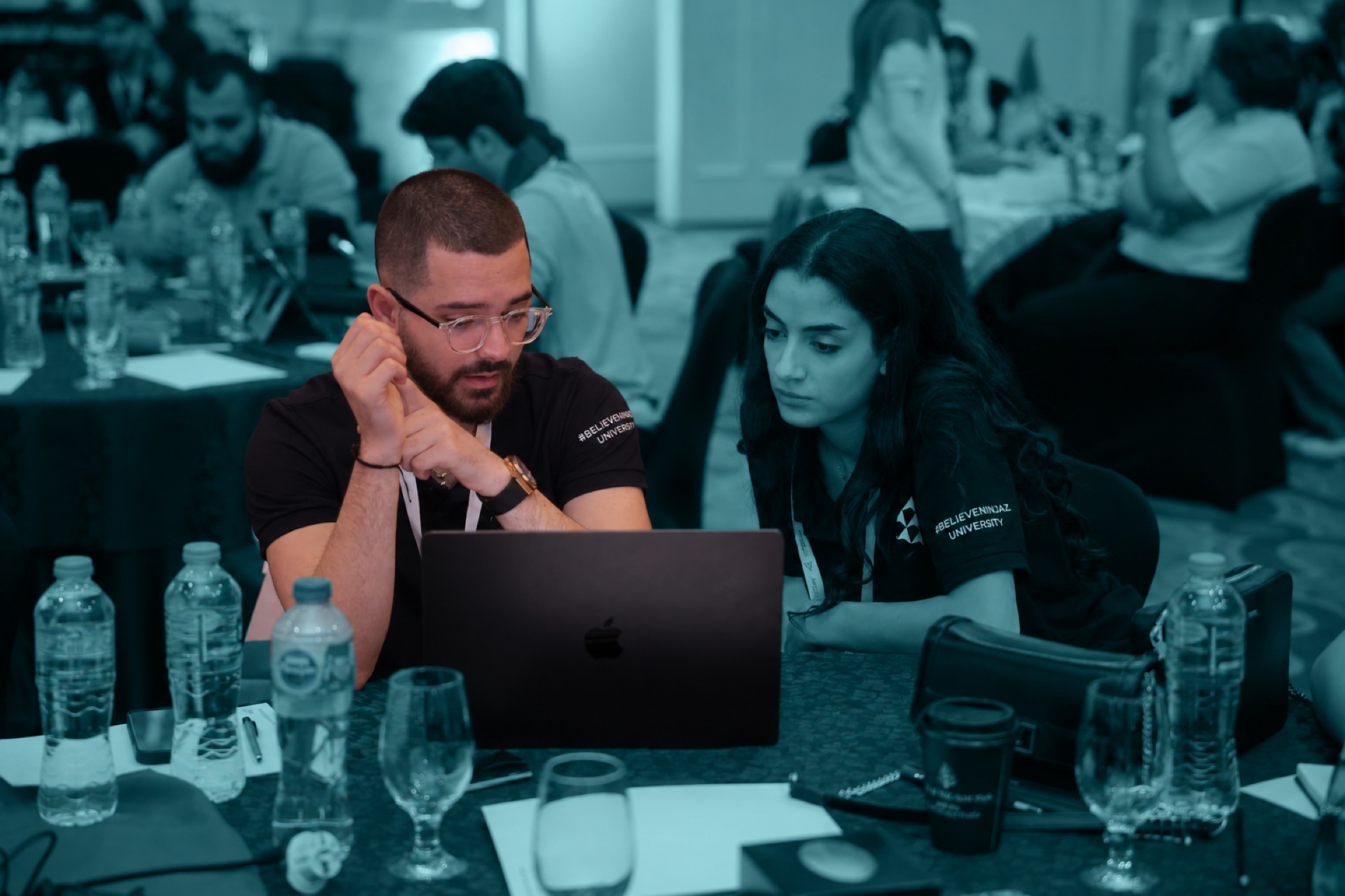 Two INJAZ participants working together on a laptop