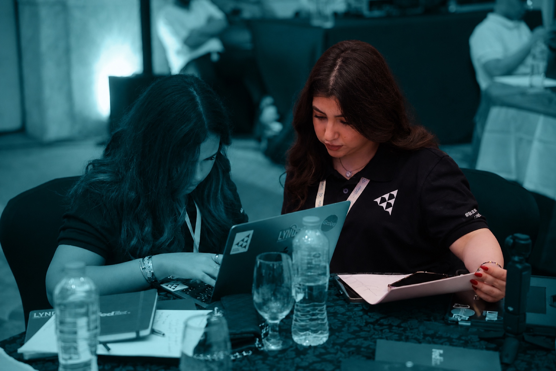 Two students reviewing work on a laptop