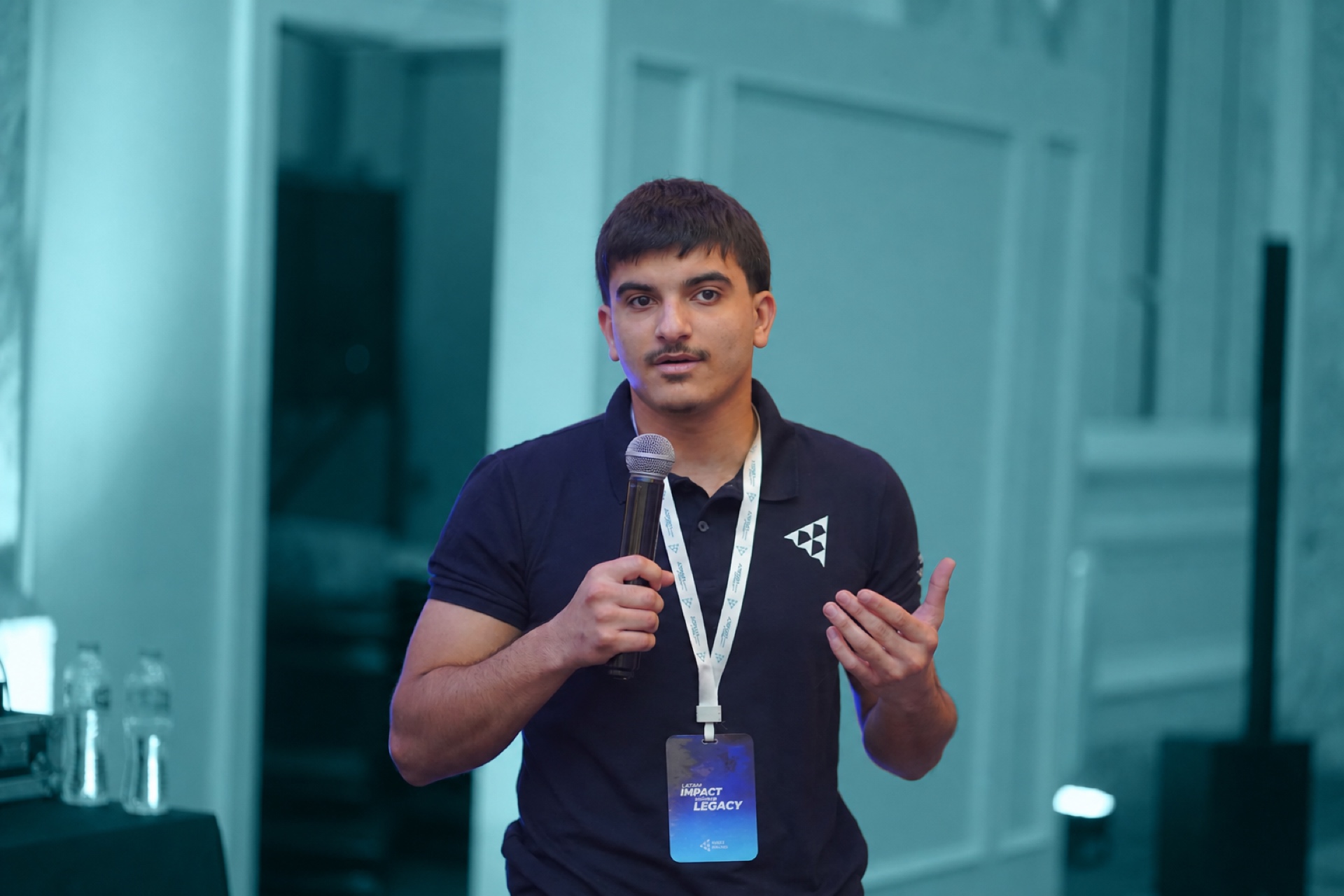 A young man presenting with a microphone